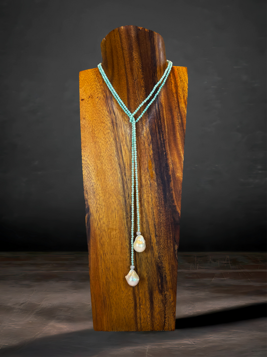 This 36" aqua quartz lariat features two Baroque freshwater pearls and CZ accents, creating an elegant statement piece with a natural twist.