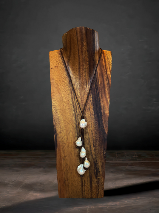 Five Baroque freshwater pearls strung on Greek leather, offering a luxurious and earthy statement piece.